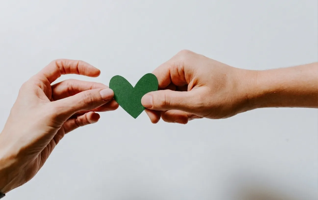 Green Hands Holding Heart